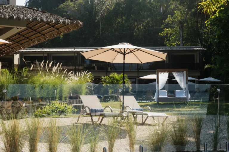 Canopy daybed and loungers by the pool in Miamar's tropical garden